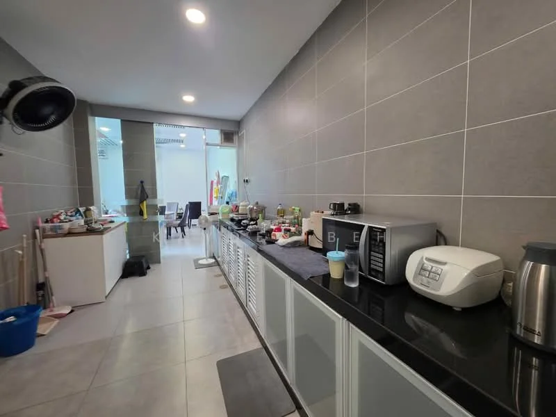 Kitchen features: grey tiled walls, white cabinetry, black countertop, stainless-steel microwave, white rice cooker, coffee machine, toaster, kettle, open shelving, floor tiles, wall-mounted ceiling fan, dining area visible in background; style: modern.