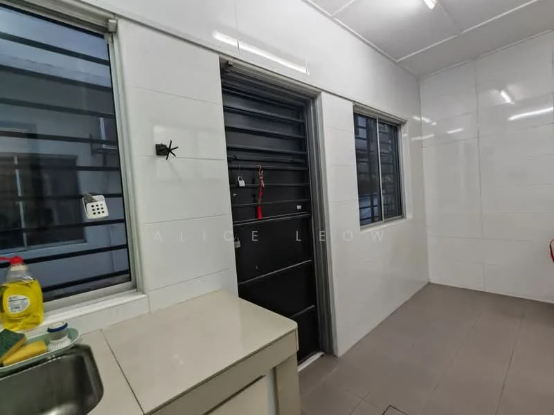 Room features: white tiled walls, grey tiled flooring, single-bowl stainless-steel sink, kitchen countertop, window with metal grille, door with security grille, bottle of dish soap, cleaning supplies, light fixtures on ceiling.
