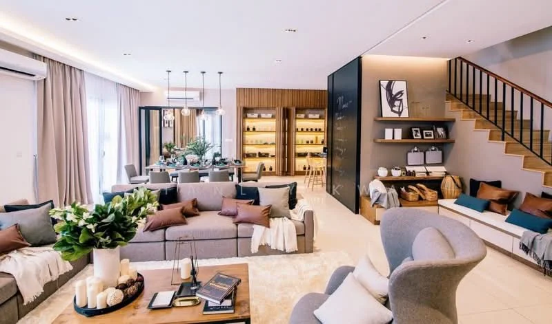 Living features: 3-seater fabric sofa in grey, 2-seater fabric sofa in beige, armchair in light grey, coffee table with wooden surface, area rug with neutral color, wall-mounted TV, built-in shelving unit with decorative items, pendant lighting with multiple bulbs, floor-to-ceiling windows with sheer curtains, recessed lighting, decorative cushions in various colors, greenery in ceramic pots, staircase with wooden handrail, wall art in black frame; style: modern.