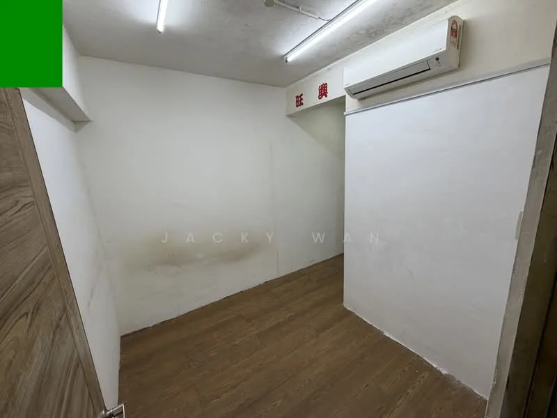 Room features: white painted walls, wooden flooring, 1 wall-mounted split AC, fluorescent ceiling lights.