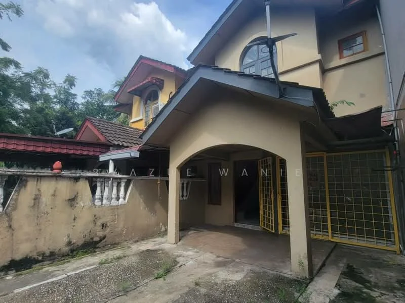Exterior type: semi-detached house; features: arched entrance with roof overhang, concrete flooring, yellow metal gate, exposed brick wall, manicured landscaping, two-storey structure, red tiled roof, cream painted facade, surrounding greenery, driveway area; style: modern.