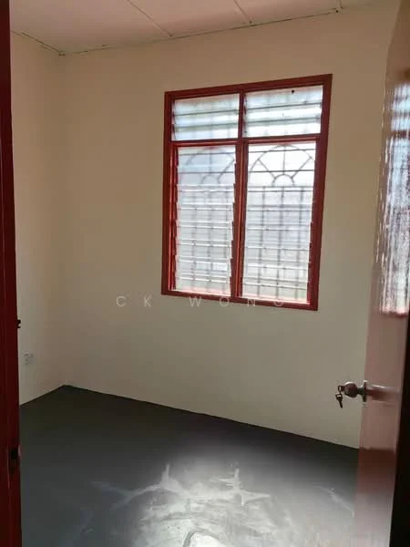 Room features: white painted walls, grey flooring, single window with red frame, door with red frame.