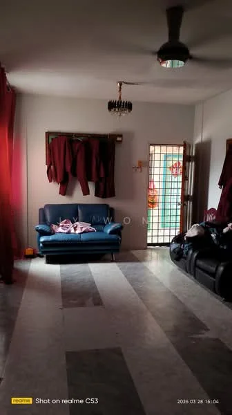 Living features: grey fabric sofa, black leather sofa, marble flooring, red curtains, ceiling fan, wall-mounted light fixture, decorative wall with window, clothes hanging on hooks.