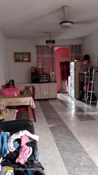 Living features: marble tile flooring, white painted walls, ceiling fan, chandelier, dining table with chairs, refrigerator, kitchenette with cabinets, open shelving, curtains, sofa, decorative items on table, laundry items on floor.