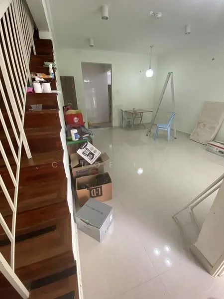 Room features: wooden staircase, white painted walls, glossy tile flooring, ceiling lights, table with chairs, ladder, boxes and clutter, open layout; style: modern.