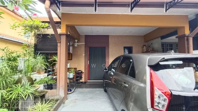 Exterior type: linked terrace house; features: car porch with awning, grey stone-paved driveway, wooden door, decorative wall with textured finish, potted plants, tropical landscaping, overhang roof, side entrance with gate; style: modern.
