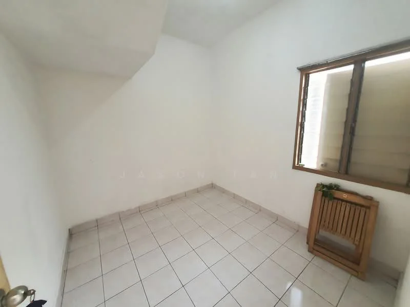 Room features: white painted walls, tile flooring, single window with wooden frame, wooden shelf, corner ceiling, natural light from window.