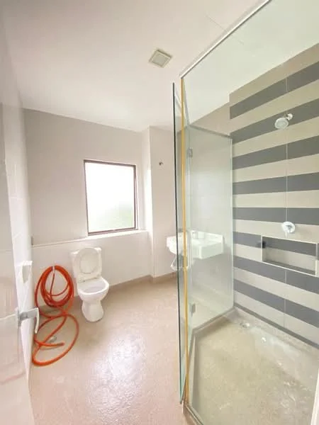 Bathroom features: glass shower enclosure, rain shower head, handheld shower, white toilet, wall-mounted sink, striped wall tiles, plain grey wall, window with natural light, light fixture in ceiling, flooring with light-colored tiles; style: modern.