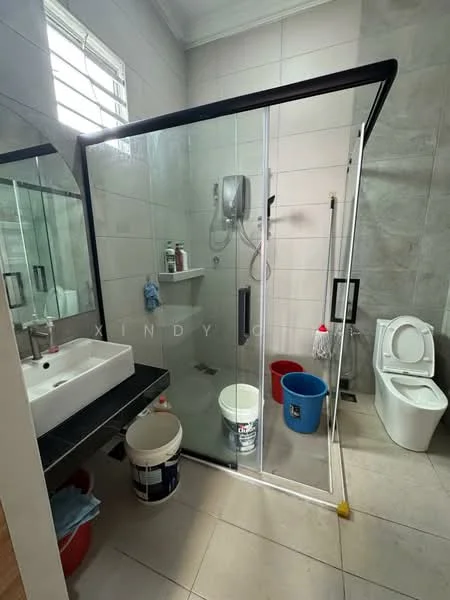 Bathroom features: glass shower enclosure, rain shower head, handheld shower, white ceramic toilet, single-sink vanity with black countertop, mirror above vanity, grey tiled walls, light grey floor tiles, buckets for cleaning, shower wall with built-in shelf; style: modern.