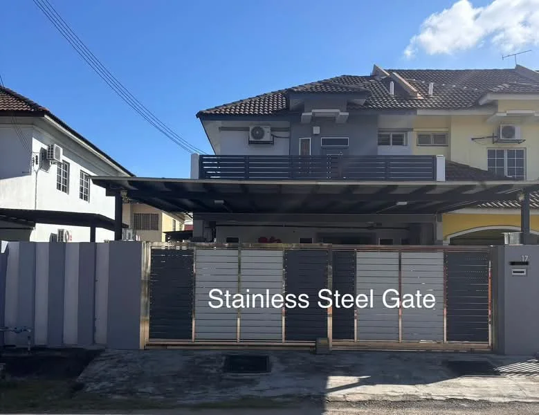 Exterior type: semi-detached house; features: stainless steel gate, covered car porch, two-storey structure, air conditioning units visible, grey painted facade, yellow painted facade, sloping tiled roof, front garden area, paved driveway; style: modern.