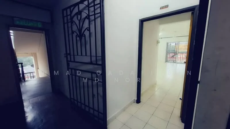 Room features: white walls, tiled flooring, metal security gate, door frame, window with view, light fixture, neutral color scheme, open layout.