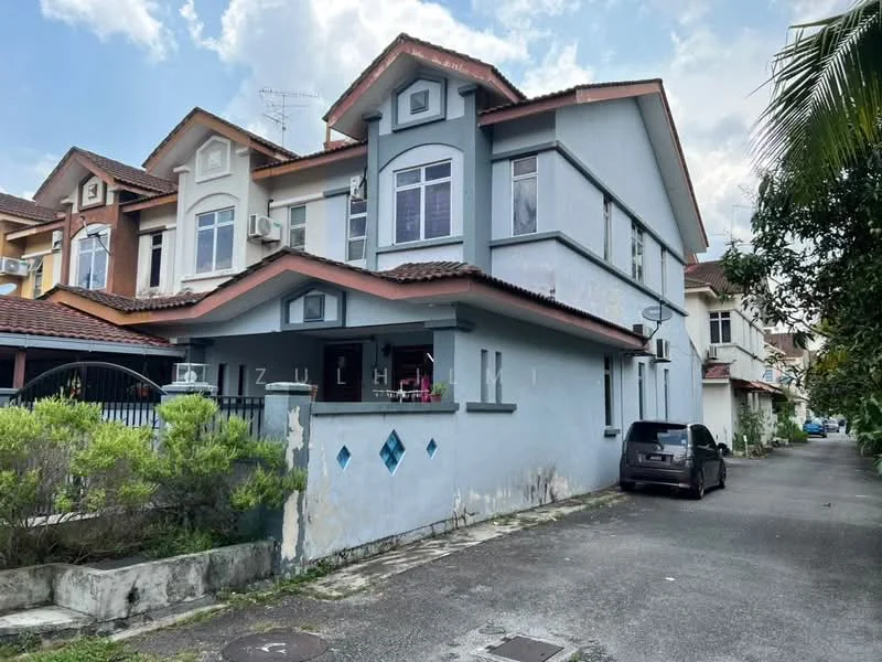 Exterior type: linked terrace house; features: two-storey building, grey painted facade, red tiled roof, front porch area, decorative diamond-shaped windows, driveway with interlocking pavers, surrounded by greenery, visible air conditioning units, gated entrance, parking space for one car; style: modern.
