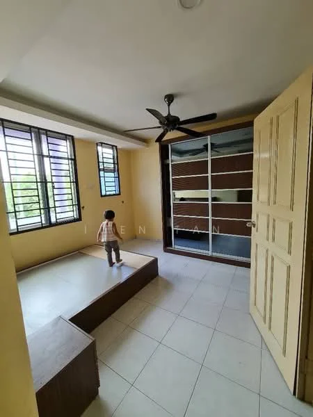 Room features: light yellow painted walls, white ceiling, ceiling fan, large windows with black metal grills, tiled flooring, built-in wardrobe with sliding glass doors, raised platform area, wooden base for platform; style: modern; view: garden.