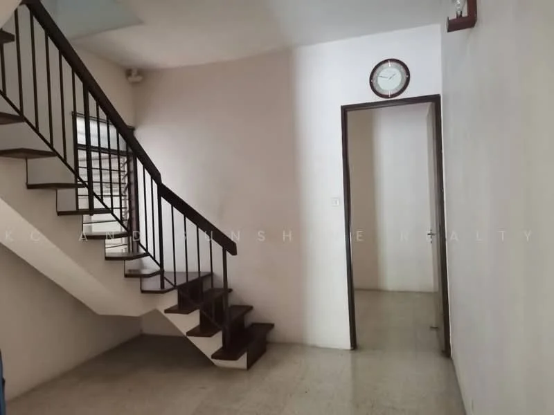 Room features: staircase with wooden steps, white painted walls, light-colored flooring, wall clock, doorway leading to another room, window with horizontal slats; style: minimalist.
