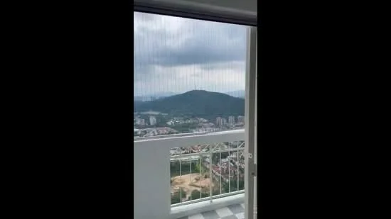 Room features: floor-to-ceiling sliding glass door, balcony railing, checkered tile flooring, mountain view, city view, grey clouds in sky; view: mountain.