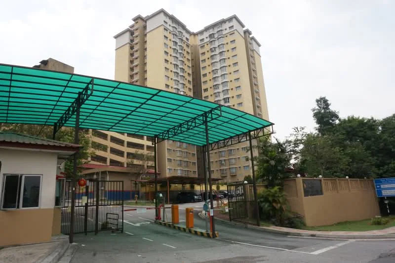 Exterior type: mid-rise condominium; features: guard house at entrance, gated entry, covered parking, multiple storeys, green awning, surrounded by greenery, manicured landscaping; style: modern.