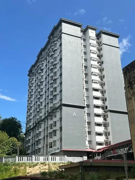 Exterior type: mid-rise condominium; features: grey painted facade, recessed balconies, approximately 10-storey high-rise, surrounded by greenery, covered entrance, multiple windows on each floor; style: modern.