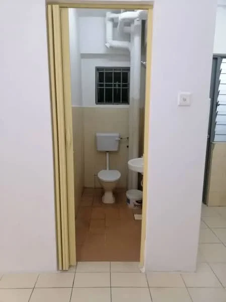 Bathroom features: white toilet, white sink, tiled flooring, cream tiled walls, window for natural light, exposed plumbing, doorway with sliding doors.