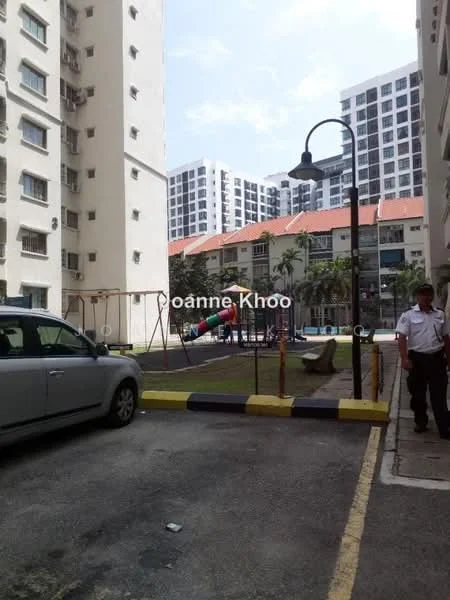 Exterior type: low-rise apartment block; features: playground with swings, manicured lawn, paved walkway, parking area, surrounding residential buildings, security guard, lamppost, children's play equipment; style: modern.
