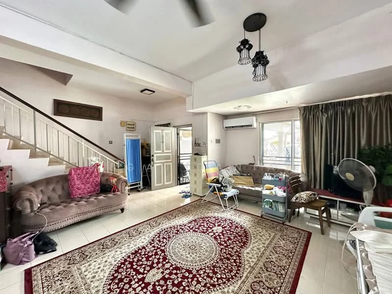 Living features: cream painted walls, white ceiling, 5-blade ceiling fan, large window with sheer curtains, brown leather sofa, 2-seater fabric sofa, decorative area rug with geometric pattern, wooden coffee table, wall-mounted air conditioning unit, staircase with wooden railing, decorative wall art, floor tiles, potted plants; style: traditional. Room features: open layout, natural light from windows.