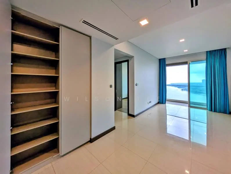 Room features: white painted walls, glossy tile flooring, floor-to-ceiling windows, blue curtains, built-in shelving unit, recessed ceiling lights, corner view, neutral color scheme; style: modern; view: sea.