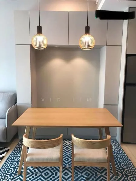 Dining features: wood dining table, 2 wooden chairs, pendant lighting with woven design, grey cabinetry, white wall, blue patterned area rug, refrigerator, neutral color scheme; style: modern.