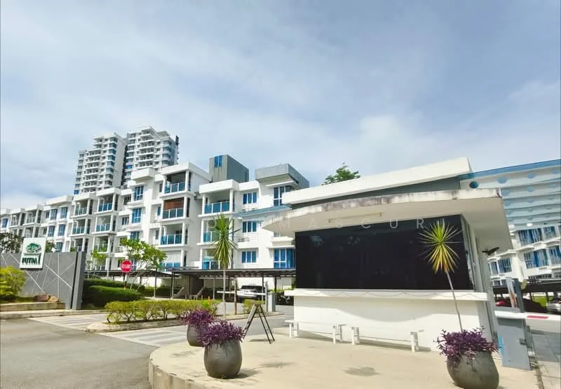 Exterior type: mid-rise condominium; features: glass curtain wall, white painted facade, blue accent panels, manicured landscaping, paved driveway, security guardhouse, visible parking area, surrounded by greenery; style: modern.