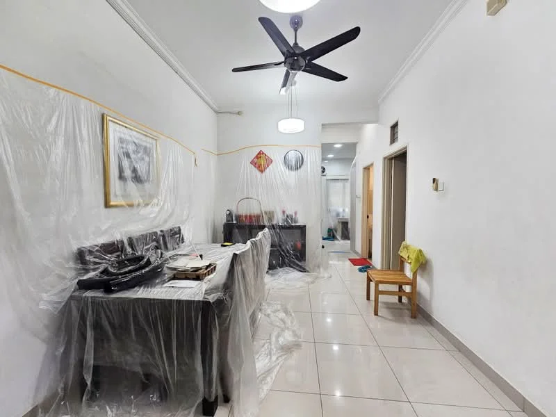 Room features: white painted walls, ceiling with crown moulding, recessed ceiling light, 5-blade ceiling fan, glossy tile flooring, wooden door, wooden chair, plastic covering on furniture, decorative wall art, small table, doorway leading to another room; style: modern.