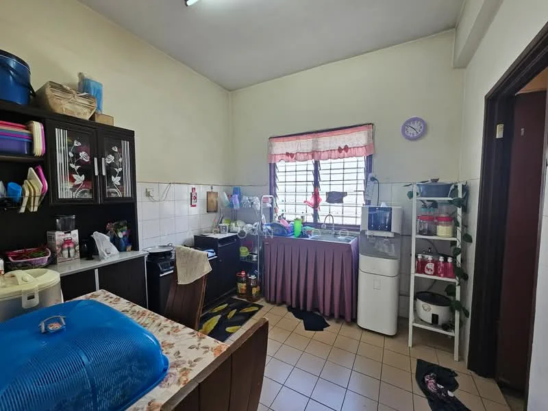 Kitchen features: white tiled walls, cream tiled flooring, wood cabinetry with glass doors, black countertop, single-bowl stainless-steel sink, chrome pull-down faucet, built-in gas stove, microwave, refrigerator, water dispenser, window with grid pattern, curtains, decorative wall clock, area rug with geometric pattern, kitchen table with floral tablecloth.