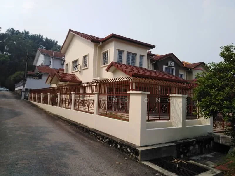 Exterior type: detached bungalow; features: white painted facade, red tiled roof, fenced perimeter, manicured lawn, driveway with interlocking pavers, two-storey structure, windows with grilles, surrounded by greenery; style: modern.