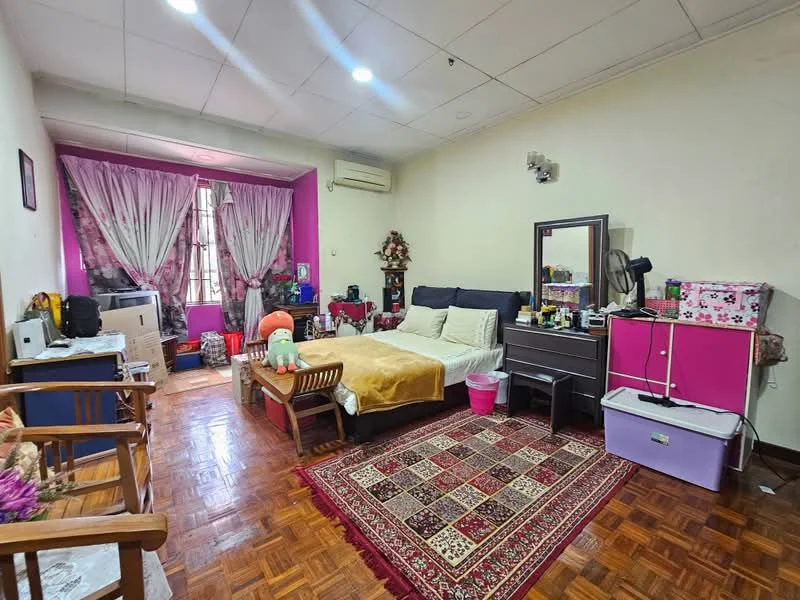 Bedroom features: wooden flooring, white painted walls, pink accent wall, ceiling lights, window with sheer curtains, queen-size bed with upholstered headboard, bedside table, dressing table with mirror, armchair, area rug with geometric pattern, storage cabinet, decorative items on shelves; style: modern.