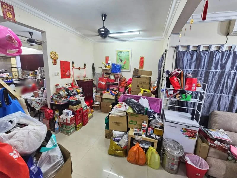 Room features: cream painted walls, white ceiling with crown moulding, floor tiles, ceiling fan, sofa, cardboard boxes, plastic bags, storage shelves, decorative wall art, various household items.