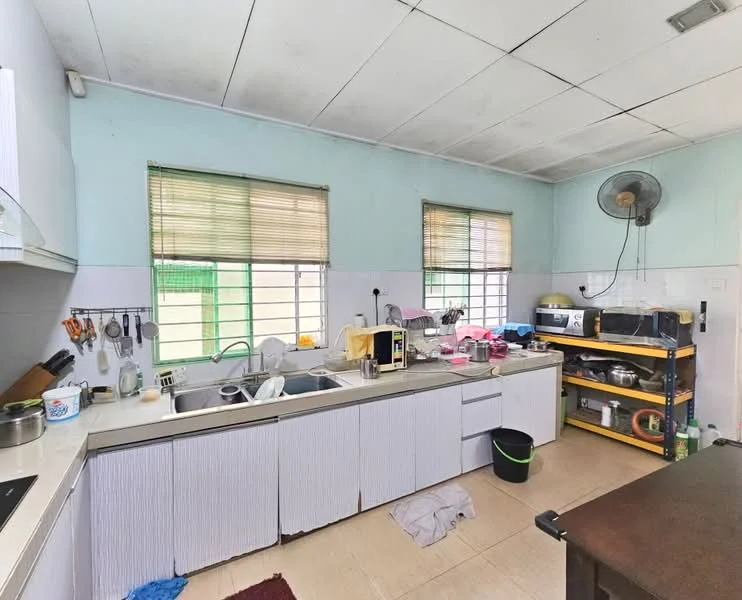 Kitchen features: white cabinetry, double-bowl stainless-steel sink, chrome pull-down faucet, black countertop, built-in stove, microwave, kitchen cart with shelves, wall-mounted fan, tile flooring, window with blinds, multiple utensils and kitchenware visible, dirty dishes on countertop, light blue painted walls.