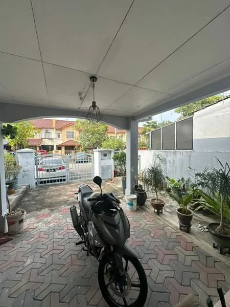 Exterior type: linked terrace house; features: paved driveway, covered car porch, hanging pendant light, potted plants, fenced perimeter, visible parking area, brick wall, garden area; style: modern.