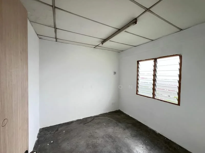 Room features: white painted walls, concrete flooring, sliding windows with metal grilles, exposed ceiling with fluorescent light fixture, built-in wardrobe with wood finish, no visible furniture or decor; style: minimalist.
