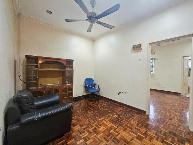 Living features: dark wood parquet flooring, white painted walls, ceiling fan, built-in wooden cabinet, black leather sofa, blue office chair, wall-mounted air conditioning unit, window with natural light.