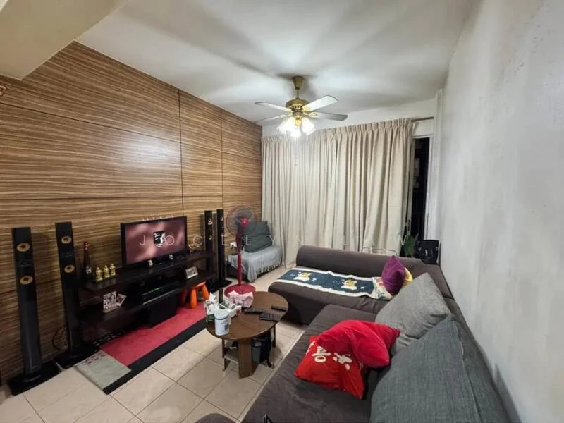 Living features: grey L-shape sectional sofa, 3-seater fabric sofa in beige, coffee table, TV console, wall-mounted TV, area rug with geometric pattern, ceiling fan with light, wood panel accent wall, cream curtains, tile flooring, decorative pillows in red and pink; style: contemporary.