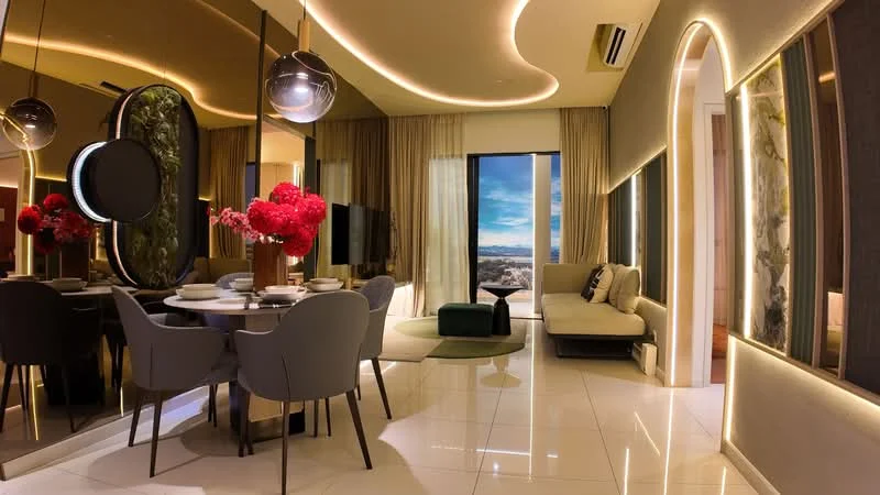 Living features: floor-to-ceiling windows, sheer curtains, recessed LED downlights, decorative wall mirror, sofa in light color, coffee table, area rug, dining table with grey upholstered chairs, vase with flowers, green accent chair, wall-mounted TV; style: modern; view: city.