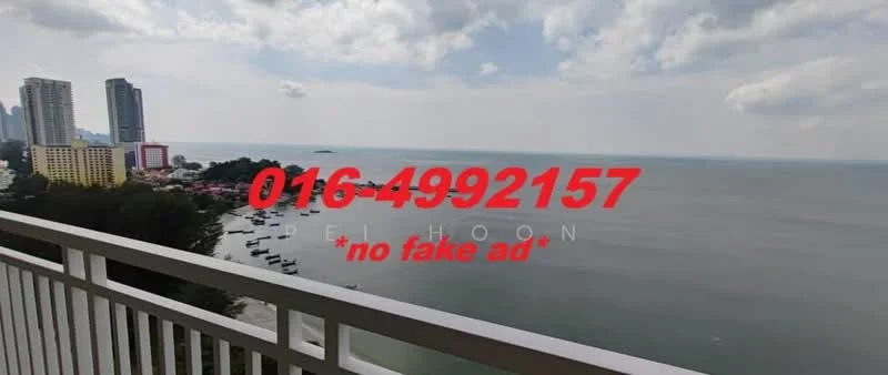 Exterior type: high-rise condominium; features: sea view, city skyline in background, balcony railing, surrounding greenery, cloudy sky, waterfront, multiple high-rise buildings; style: modern.