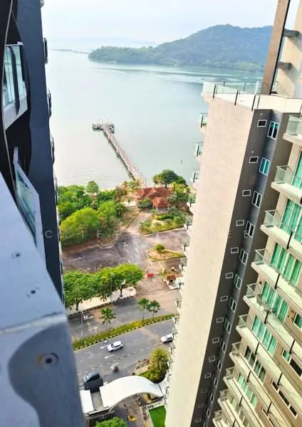 Exterior type: high-rise condominium; features: waterfront view, surrounding greenery, adjacent to a pier, road access, landscaped gardens, palm trees, mountain view in background; style: modern.
