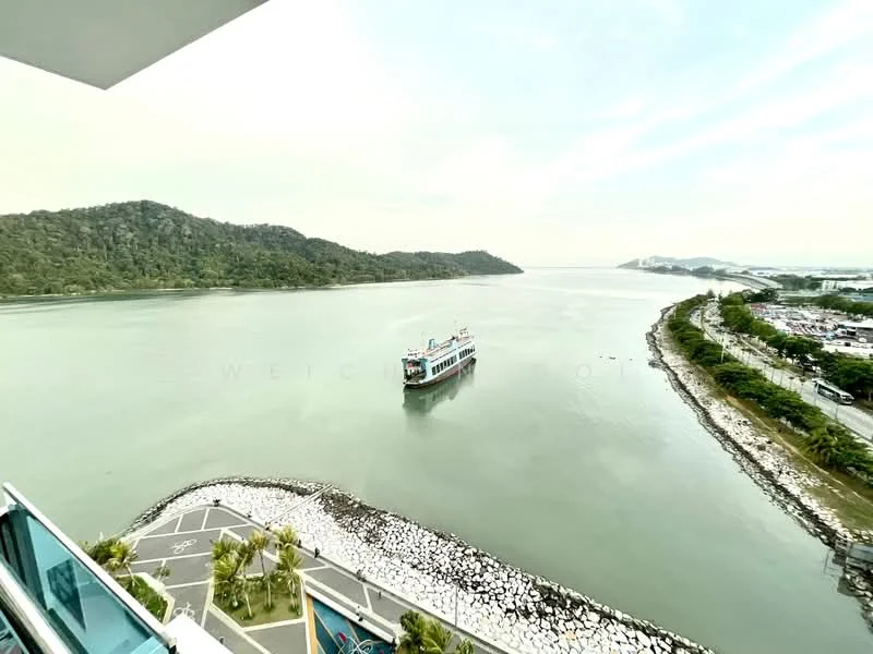 Exterior features: waterfront view, mountainous landscape in background, boat on water, paved walkway, landscaped area with palm trees, rocky shoreline.