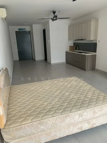 Room features: grey tiled flooring, white painted walls, ceiling fan, kitchen cabinetry in light wood, dark countertop, open layout, single wall with no visible appliances, empty space for furniture, doorway leading to another room, window with natural light; style: modern.