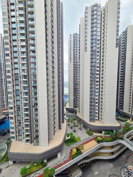 Exterior type: high-rise condominium; features: glass curtain wall, balconies on multiple floors, landscaped gardens at ground level, swimming pool visible, manicured pathways, modern architectural design, multiple towers, outdoor seating areas; style: modern.