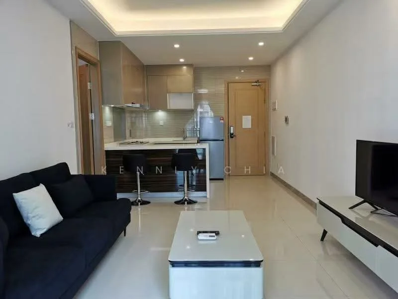 Living features: 3-seater fabric sofa in dark blue, coffee table with white top, wall-mounted TV, TV console in white, recessed ceiling lights, light-colored walls, glossy tile flooring, open-plan layout with kitchen, bar stools at kitchen counter, kitchen cabinetry in wood finish, stainless-steel fridge, kitchen countertop in light color; style: modern. Kitchen features: stainless-steel sink, built-in oven, 4-burner gas hob, kitchen cabinetry in wood finish, light-colored countertop, refrigerator, bar counter with stools; style: modern.