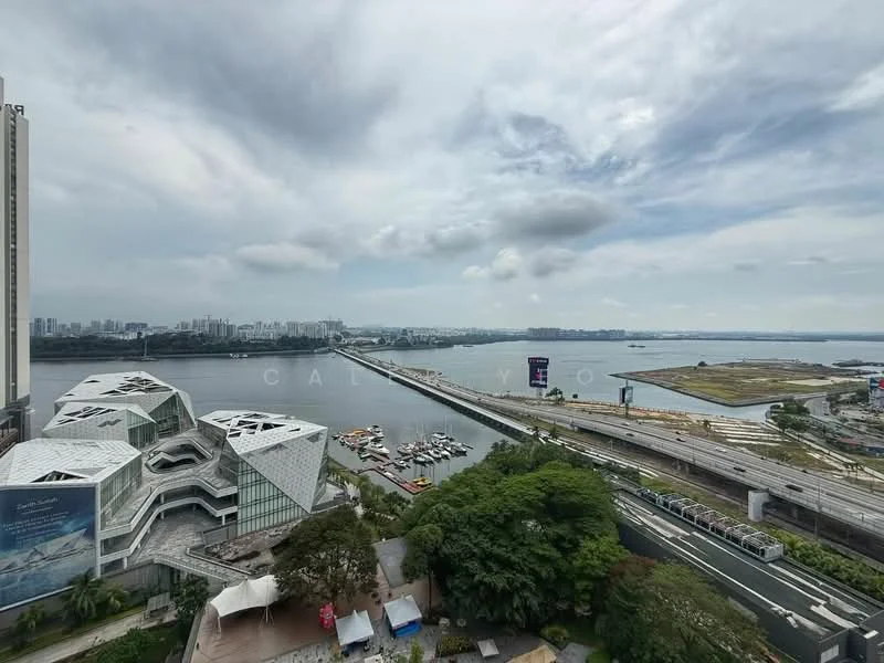 Exterior features: waterfront view, city skyline in background, green landscape, highway visible, boats in water, cloudy sky; style: modern.