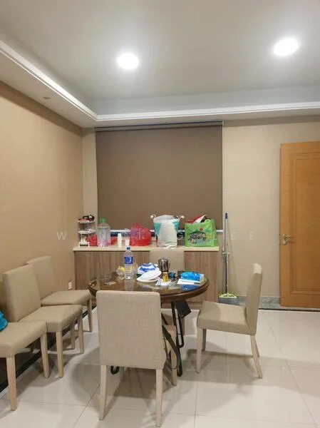 Dining features: round dining table, 4 beige upholstered dining chairs, cream painted walls, recessed downlights, tile flooring, window with roller blinds, decorative wall paneling, various items on the table, cleaning supplies in the corner; style: modern.