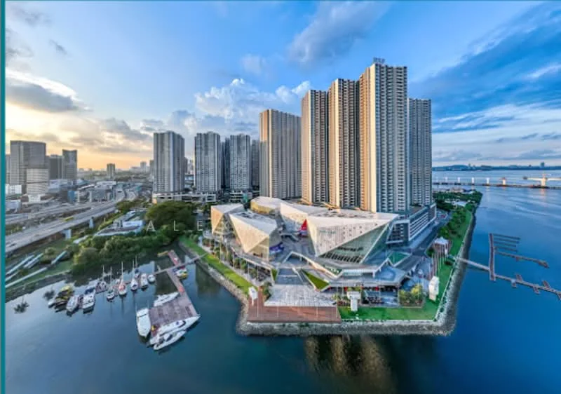 Exterior type: high-rise condominium; features: glass curtain wall, projecting balconies, manicured lawn, surrounded by water, adjacent to marina, multiple high-rise buildings, urban skyline in background, modern architectural design, landscaped garden area, boats docked at marina; style: modern.