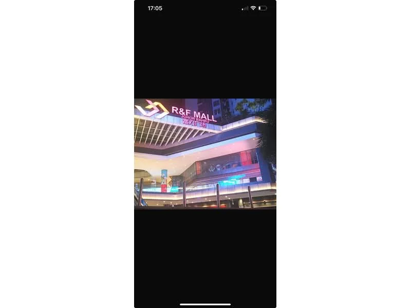 Exterior type: shopping mall; features: illuminated signage, multi-level structure, glass facade, outdoor seating area, canopy overhang, decorative lighting, entrance with escalators, large windows, modern architectural design; style: modern.