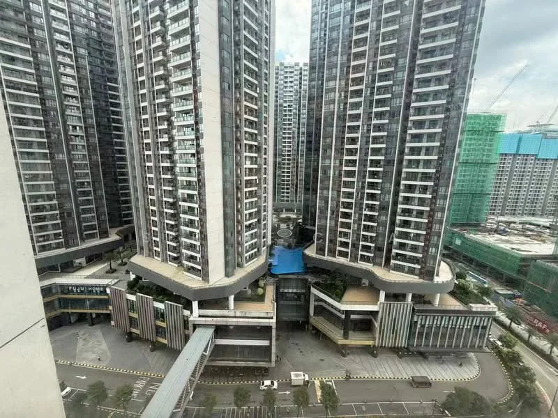 Exterior type: high-rise condominium; features: glass curtain wall, multiple high-rise towers, landscaped courtyard, swimming pool area, covered walkways, parking area, surrounded by construction sites, urban context with nearby buildings; style: modern.