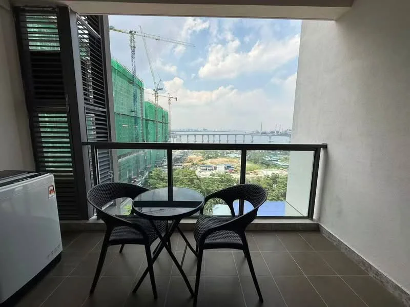 Balcony features: glass railing, outdoor dining table, two wicker chairs, floor tiles, city view, partial sea view, construction cranes in the background, green construction netting; style: modern; view: city.